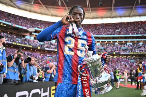 Romain Esse of Crystal Palace holding the FA Cup trophy.