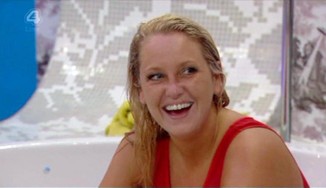 Josie in a red swimsuit laughing in the Ultimate Big Brother house.