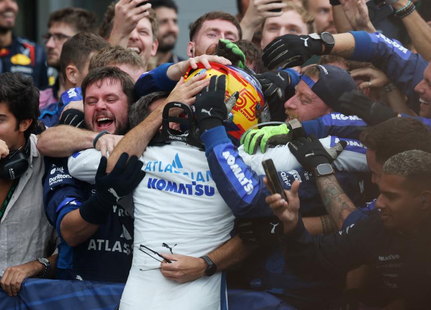 Carlos Sainz Jr. celebrating with his Williams team after finishing third in the Azerbaijan Grand Prix.