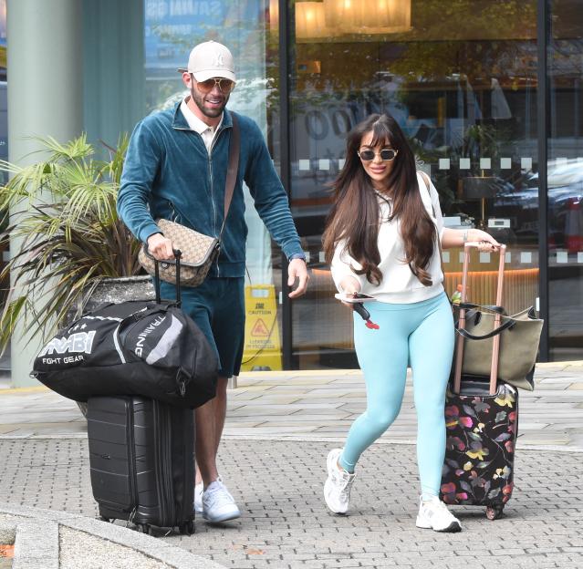 Jack Fincham and Chloe Brockett leaving a hotel in Manchester with luggage.