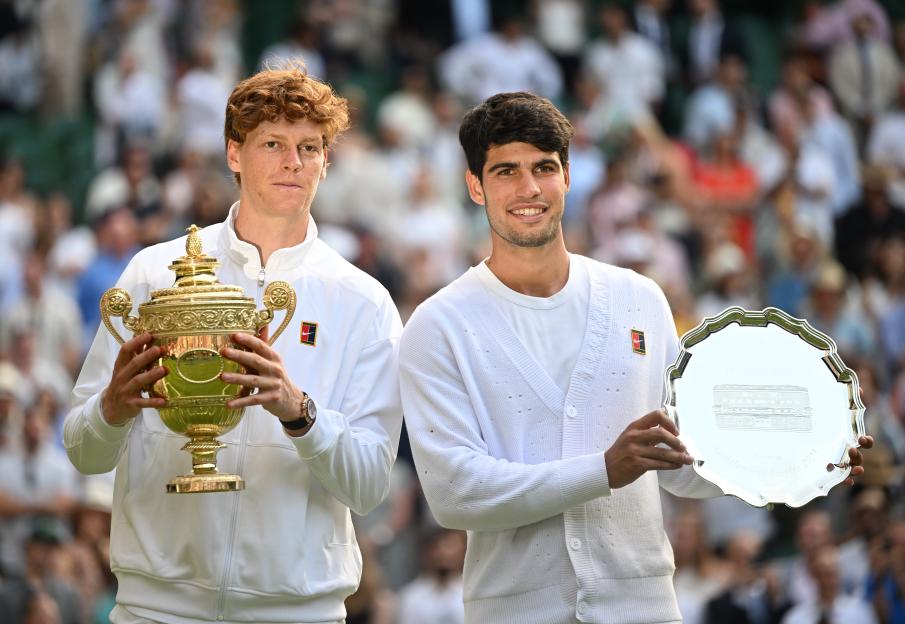 Jannik Sinner and Carlos Alcaraz pose with their trophies at the Wimbledon Men's Singles Final.