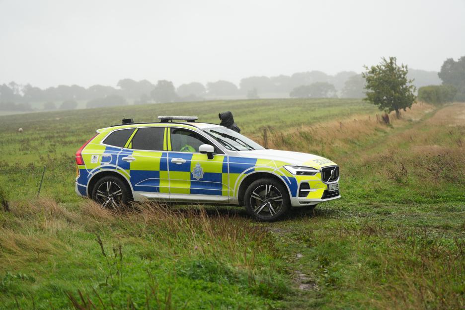 Police car in a field.