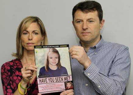 Kate and Gerry McCann holding a missing person poster for their daughter, Madeleine.