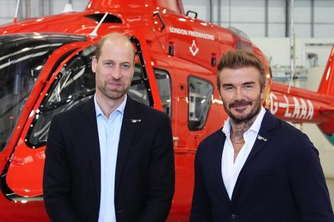 Prince William and David Beckham in front of a London Air Ambulance helicopter.