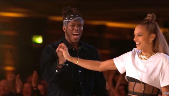 Two judges giving a golden buzzer to an auditioner.