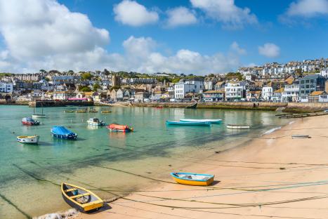St Ives fishing harbor with boats and buildings.