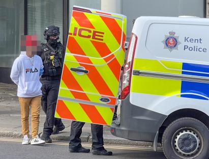 Police officer arresting a person.