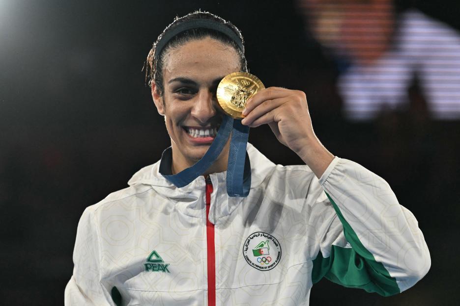 Algerian boxer Imane Khelif holding her gold medal.
