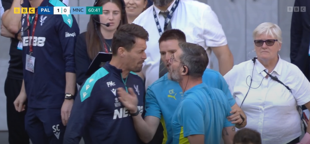 Two soccer coaches arguing.