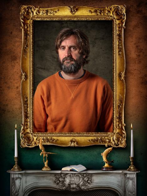 Joe Wilkinson, a contestant for BBC1's The Celebrity Traitors, looking directly at the viewer in a golden frame.
