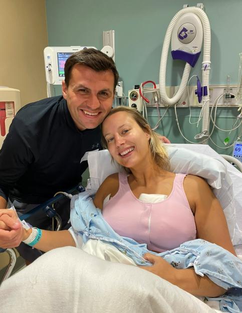 A smiling couple in a hospital room.