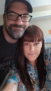 A woman and a man posing for a selfie.