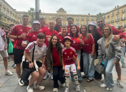 Group of Manchester United fans posing for a photo.