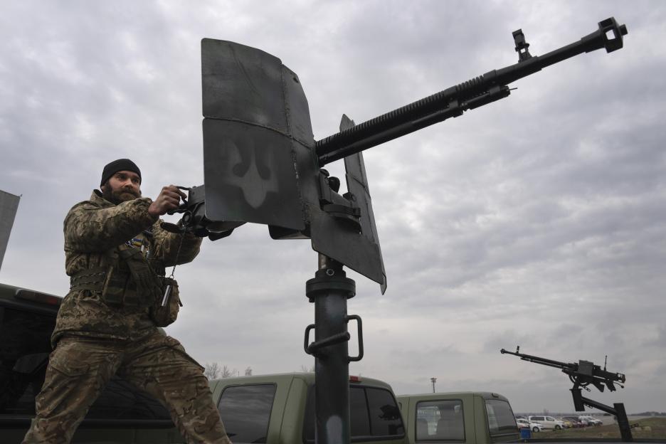 Ukrainian soldier demonstrating a mobile air defense unit at Antonov airport.