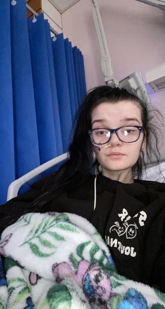 Young woman in hospital bed.