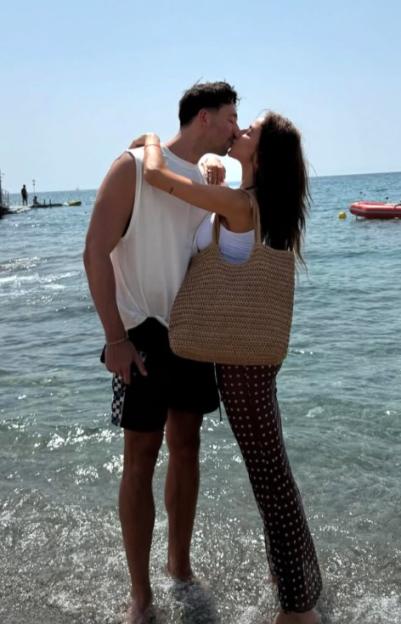 Couple kissing on a beach.