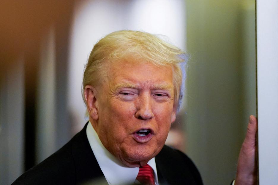U.S. President Donald Trump speaks to members of the media on Air Force One.