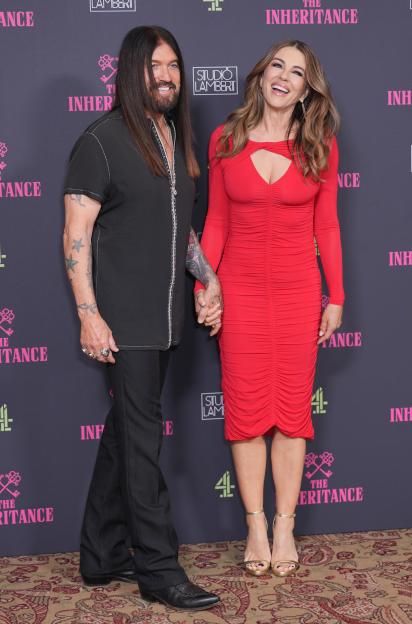 Billy Ray Cyrus and Elizabeth Hurley at the premiere of *The Inheritance*.