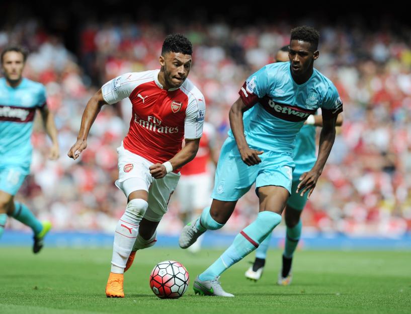 Alex Oxlade-Chamberlain of Arsenal dribbling past Reece Oxford of West Ham United.