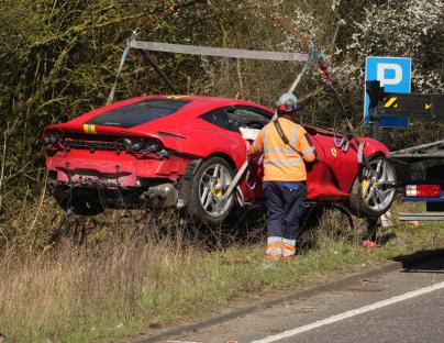 Incredible Ferrari worth £230,000 CRASHES off carriageway & flips onto its roof – forcing major road to close