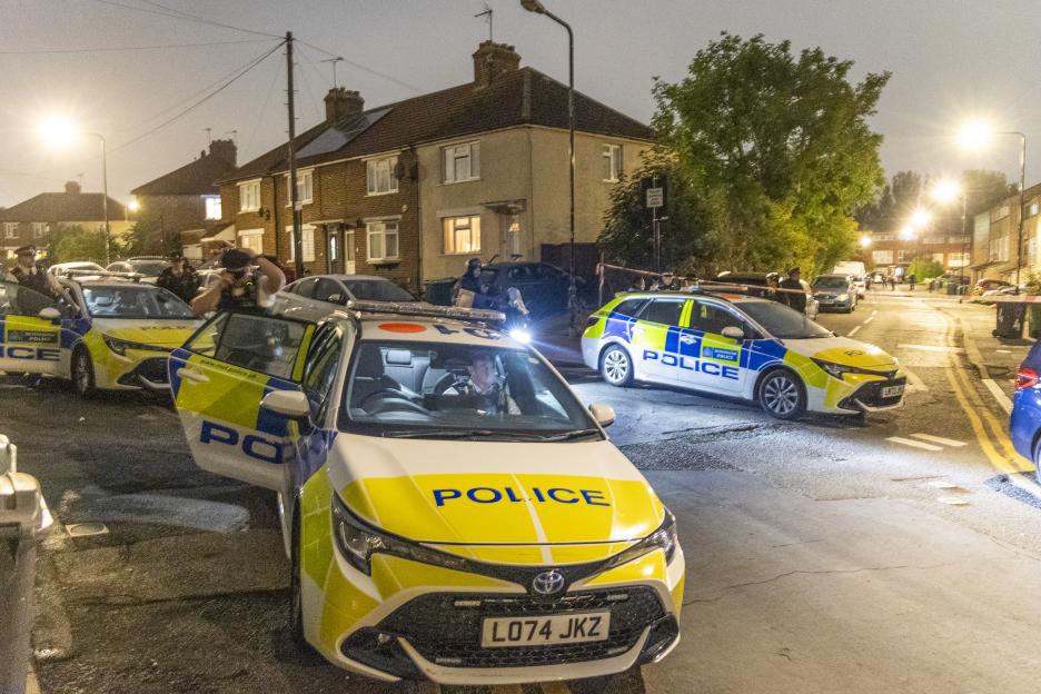 Police officers at a crime scene in Walthamstow, North London, following a shooting.