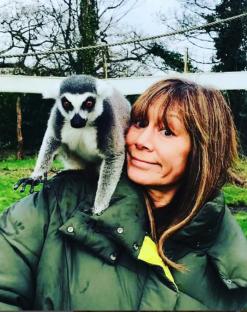 Woman with lemur on her shoulder.