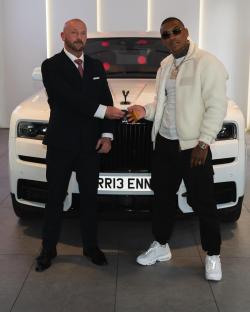 Conor Benn receiving car keys in front of a white Rolls Royce.