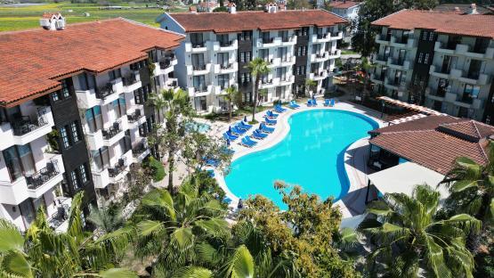 Aerial view of Lemas Suite Hotel in Turkey, showing the buildings, pool, and surrounding landscaping.