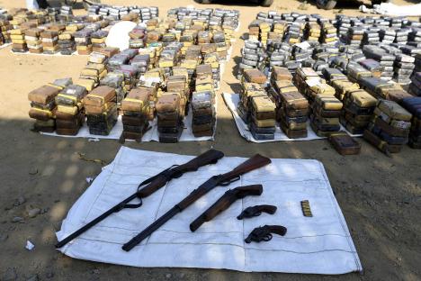 Confiscated cocaine bricks and firearms.