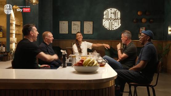 Five people sitting at a bar, laughing and talking.