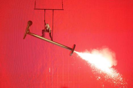 Erika Vikman of Finland performing on a giant microphone prop with pyrotechnics during the Eurovision Song Contest.