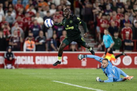 Soccer player scoring a goal.