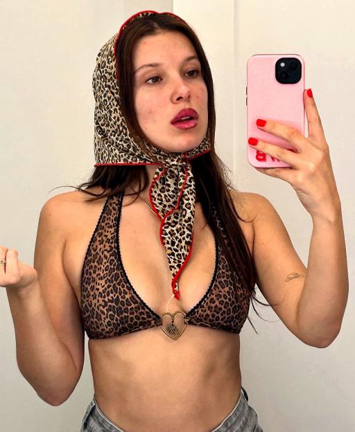 Selfie of Millie Bobby Brown wearing a leopard print headscarf and bikini top.