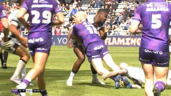 Rugby players tackling during a match.