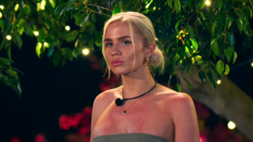 A blonde woman looking distressed.