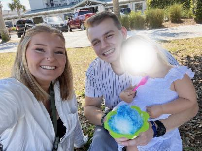 Family enjoying shaved ice outdoors.