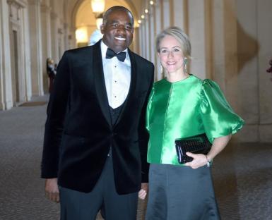 Couple in formal wear posing outdoors.