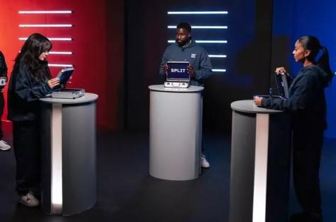 Three people participating in a game show, each with a briefcase.