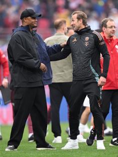 Vincent Kompany and Harry Kane on a soccer field.