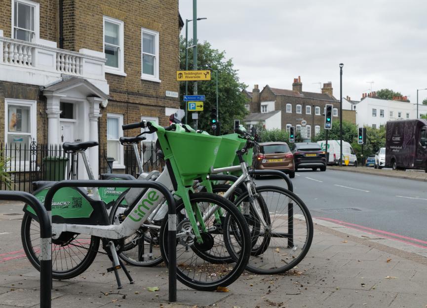 Lime bikes parked on a sidewalk.