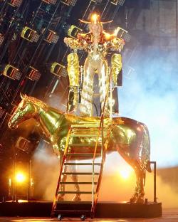 Beyoncé on a golden horse during a concert.