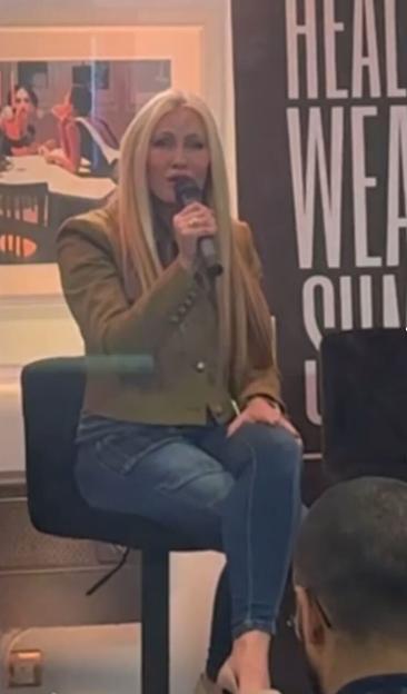 Caprice Bourret speaking into a microphone.