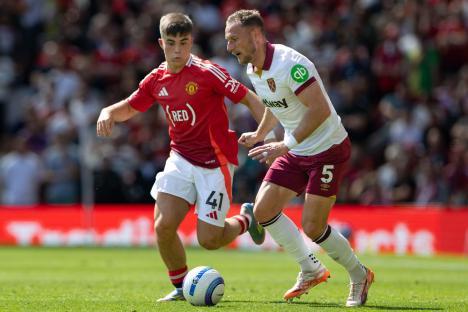 Manchester United's Harry Amass and West Ham United's Vladimir Coufal competing for the ball during a Premier League match.