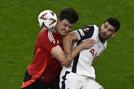 Harry Maguire of Manchester United and Dominic Solanke of Tottenham Hotspur vying for the ball.