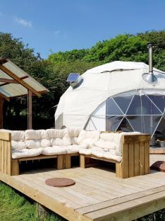 Geodesic dome with outdoor seating area.