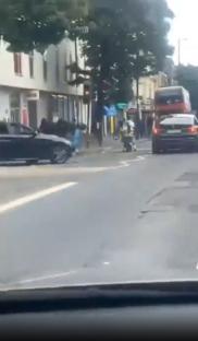 Street brawl where a driver runs over a cyclist.