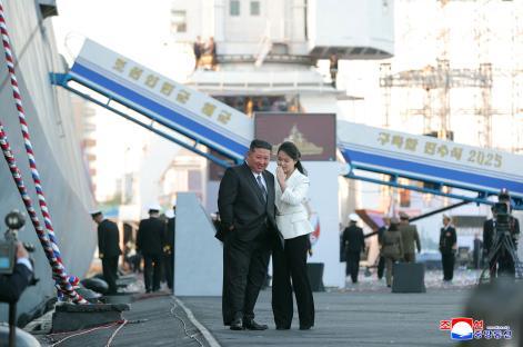 Kim Jong Un and his daughter at a North Korean warship launch ceremony.