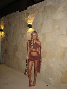 Connie Grace in a brown cutout dress.