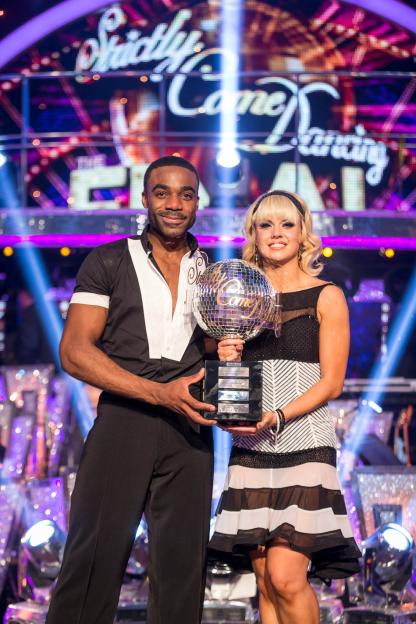 Joanne Clifton and Ore Oduba holding the glitterball trophy after winning Strictly Come Dancing.