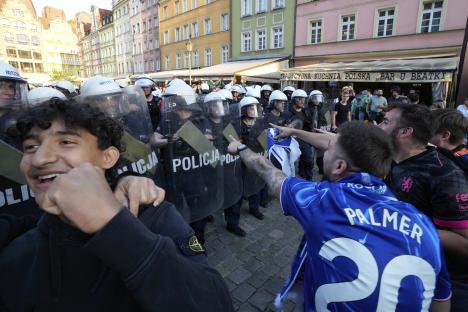 Riot police confronting Chelsea fans.